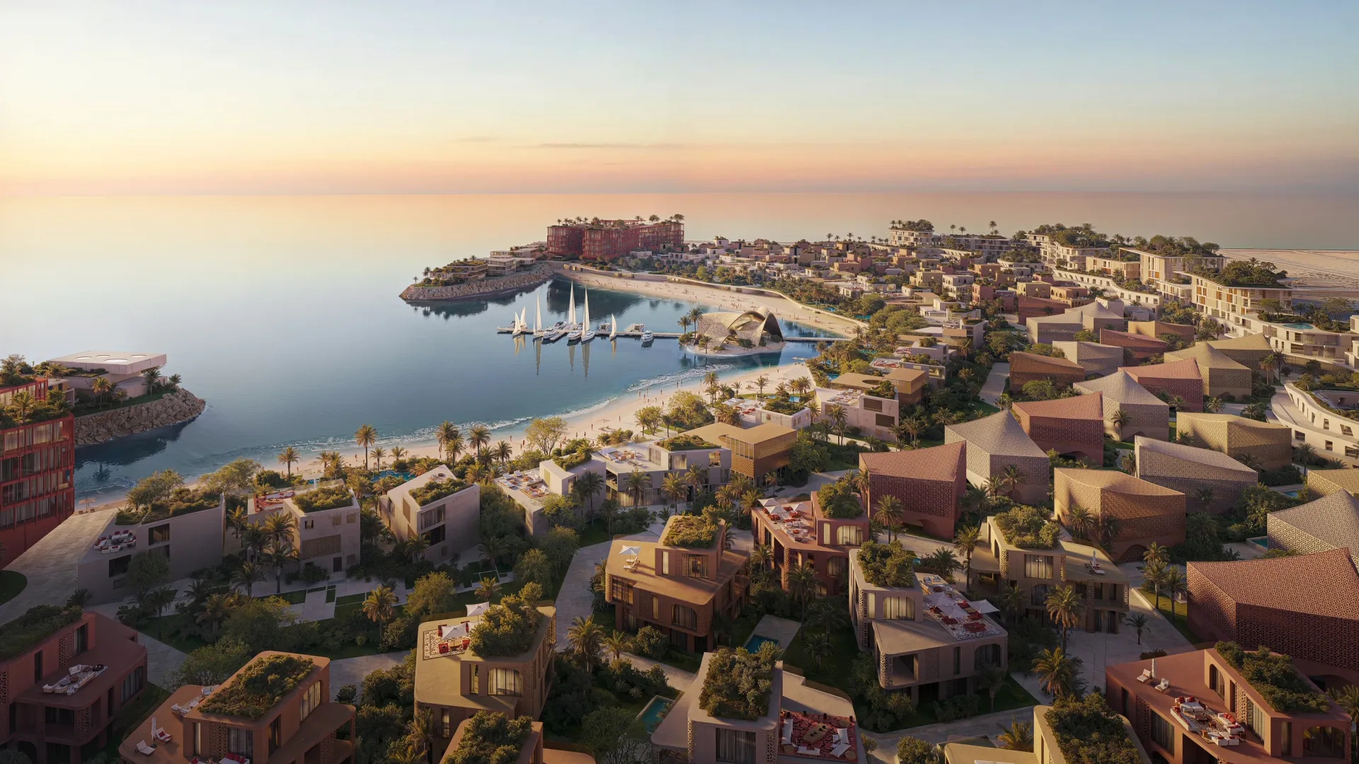 Mira Coral Bay from the air at dusk: villa clusters and apartment buildings around the bay, marina and beach clubs