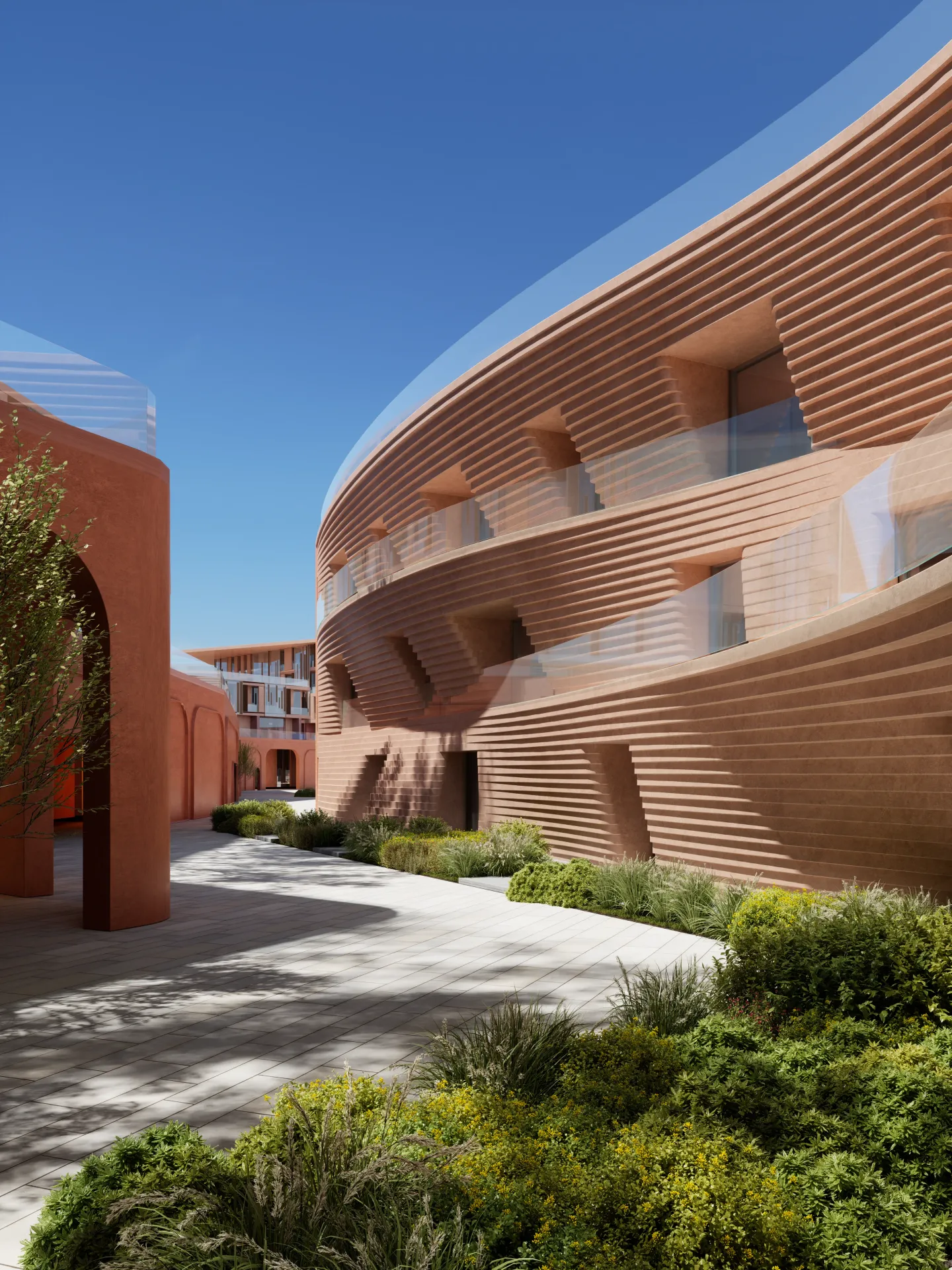 Curved, coral-textured facades around a planted Mira Coral Bay courtyard