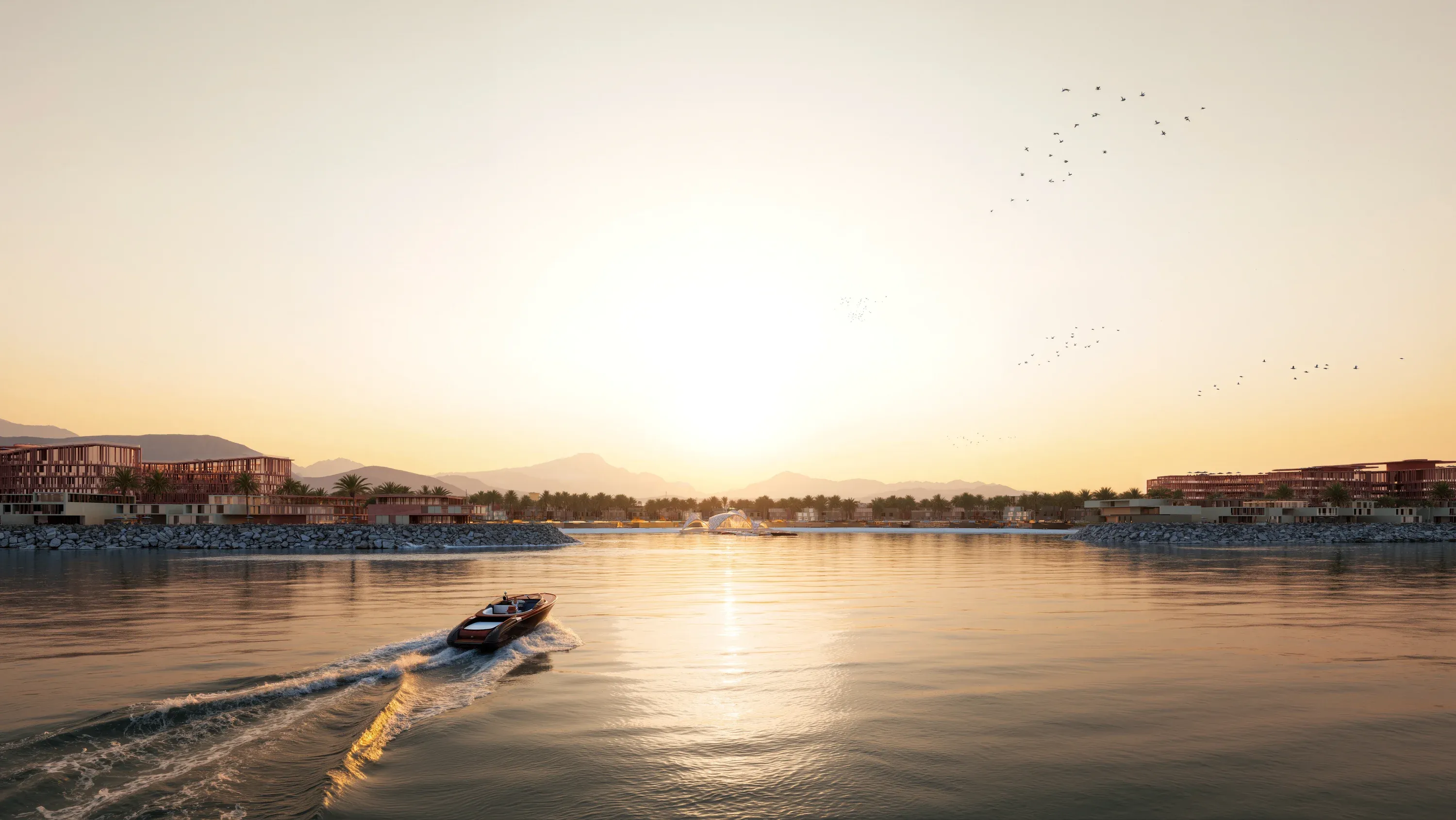 A boat crossing the Mira Coral Bay lagoon at sunset, the Hajar mountains on the horizon