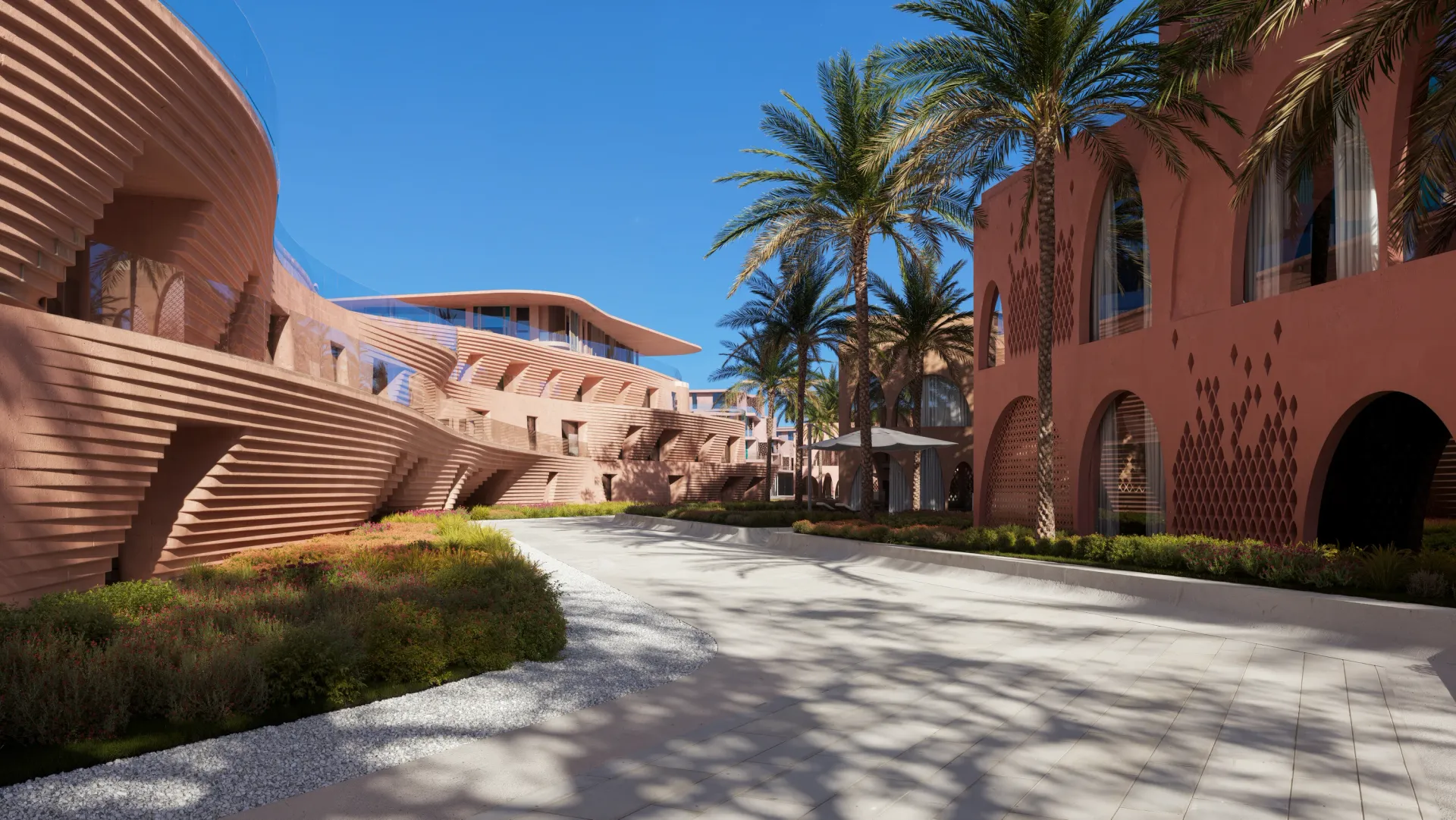 A palm-lined street between coral-toned Mira Coral Bay residences